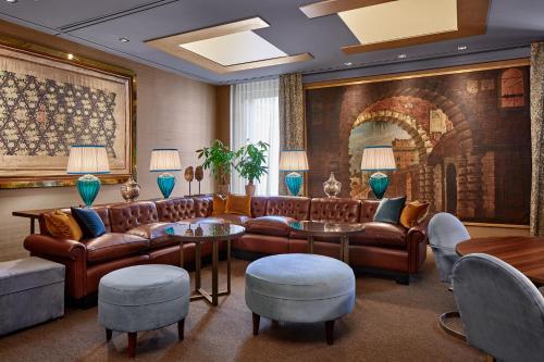 a living room with a couch and tables and chairs at Hotel Accademia in Verona