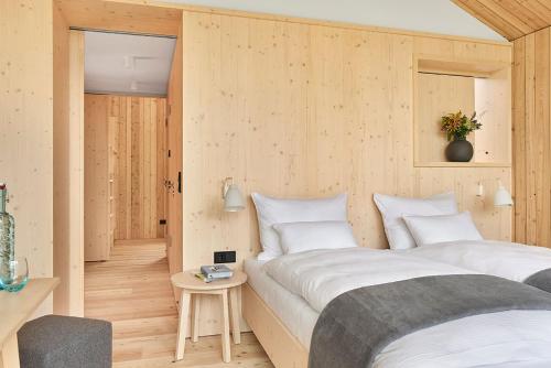 a hotel room with two beds and a table at Kulturhof Stanggass in Bischofswiesen