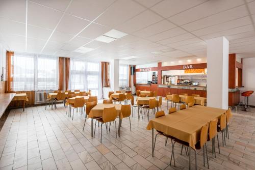 a dining room with tables and chairs in a restaurant at HOTEL AGRI in Soběšice