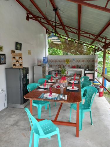 a dining room with a long table and chairs at Happy Bear in Moalboal