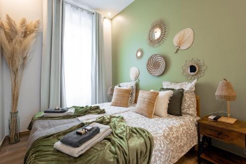 - une chambre avec un grand lit et des miroirs sur le mur dans l'établissement L'atelier des Artistes -Écrin de sérénité au coeur de Cannes - Balcon - Clim - Wifi, à Cannes