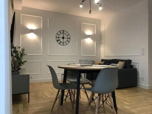 a dining room with a table and chairs at Garden Gates - luxury apartment in the heart of Gdańsk old town in Gdańsk