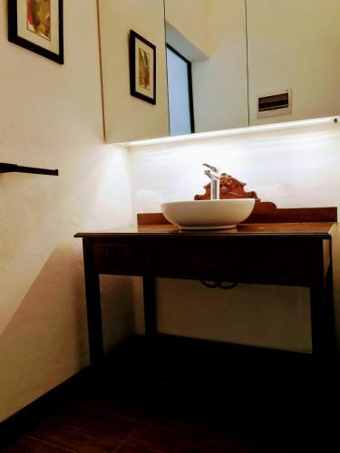a bathroom counter with a sink and a mirror at La Vista - Un lugar de Ensueño in Samaipata