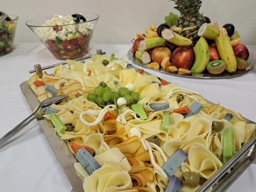 a tray of pasta and vegetables on a table at Hasičský hotel Přibyslav in Přibyslav