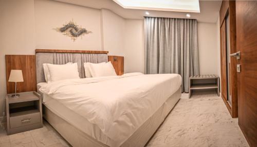 a bedroom with a large bed in a room at sas blue suites in Jeddah