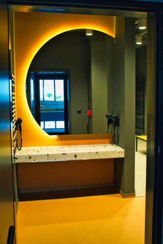 a mirror in a bathroom with a yellow counter at Novotel Szczecin Centrum in Szczecin