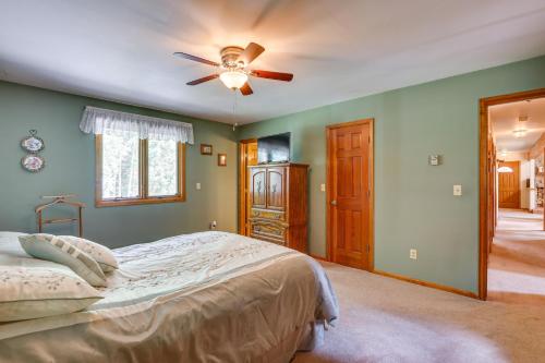 a bedroom with a bed and a ceiling fan at Silver Plume Mountain Haven with Views and Deck! in Silver Plume