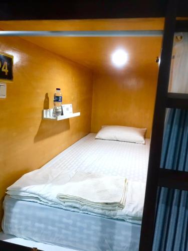a bunk bed in a room with a bottle of water at Bu Sepuh GuestHouse in Sangkanurip
