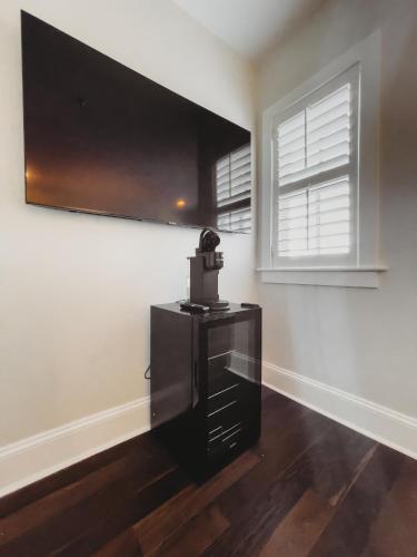 a living room with a black dresser and a window at The Jefferson Inn in Southern Pines