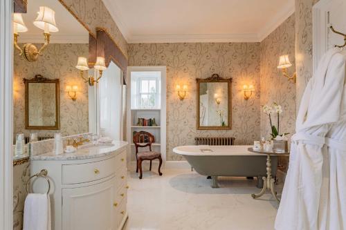 a bathroom with a tub and a sink and a bath tub at Glenapp Castle in Ballantrae