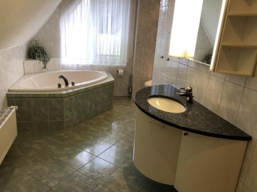 a bathroom with a bath tub and a sink and a bath tub at Nehmzowsgang 13 in Zingst