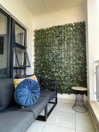 a couch sitting in front of a green wall at Home away from home in Avondzon