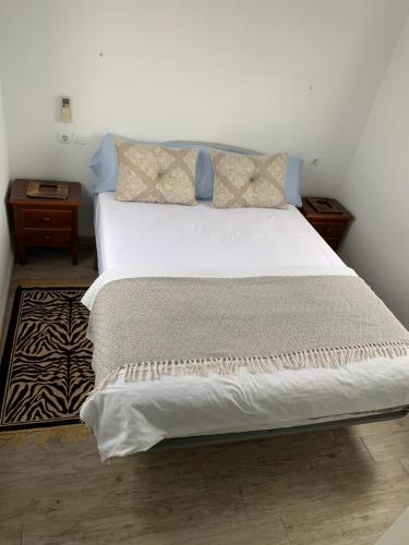 a bedroom with a large bed with white sheets and pillows at Chalet Jamaica 2 in Peniscola
