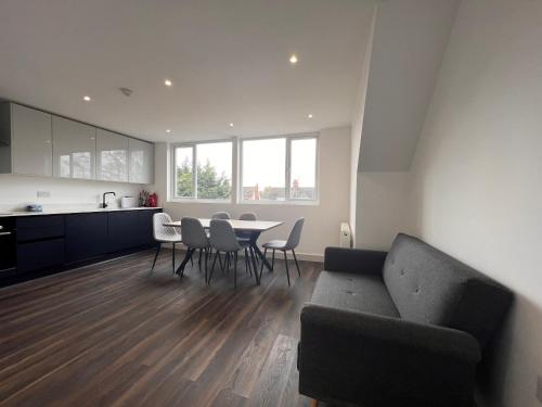 a living room with a couch and a table with chairs at Star London Finchley Road 3-Bed Abode in London