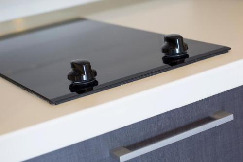a shelf with two black knobs on a counter at Villa Nena in Makarska