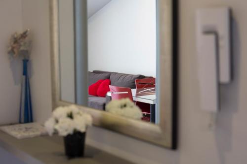 a mirror reflection of a couch in front of a mirror at Villa Nena in Makarska