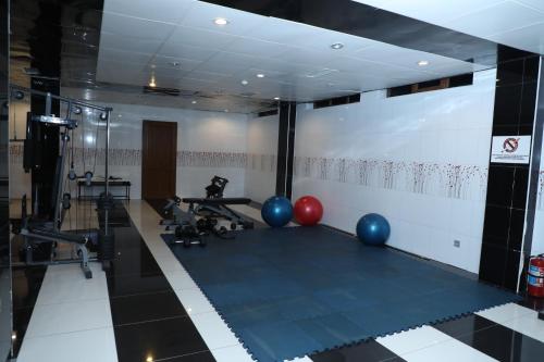 a gym with blue and red balls on the floor at Modern Hotel in Baku