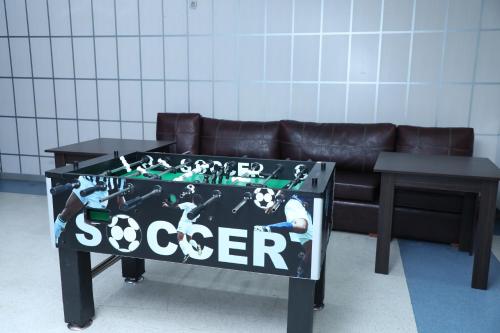 a table with a sign on it in front of a couch at Modern Hotel in Baku