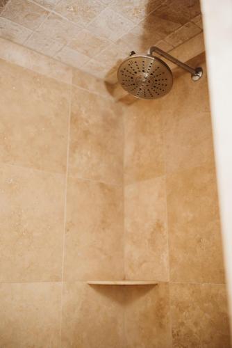 a shower with a shower head in a bathroom at The Jefferson Inn in Southern Pines