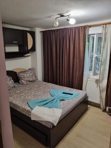 a bedroom with a bed with blue towels on it at Vila Madalina in Eforie Sud