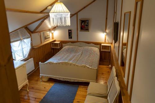 a small bedroom with a bed in a attic at Aurantola in Jaala