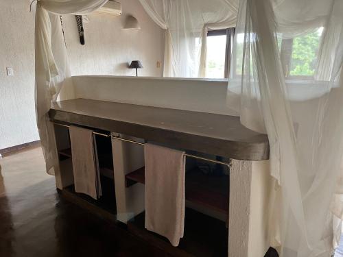 a bathroom with a large tub and a mirror at Nyati Safari Lodge in Hoedspruit
