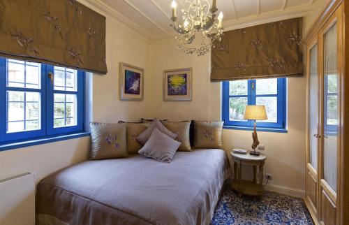 a bedroom with a bed in a room with windows at Zagori Suites Luxury Residences in Vitsa