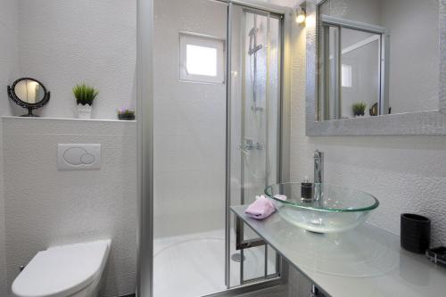 a bathroom with a glass bowl sink and a shower at Villa Nena in Makarska