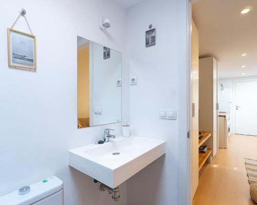 a white bathroom with a sink and a mirror at Tiny House By Casa Maui in Corralejo