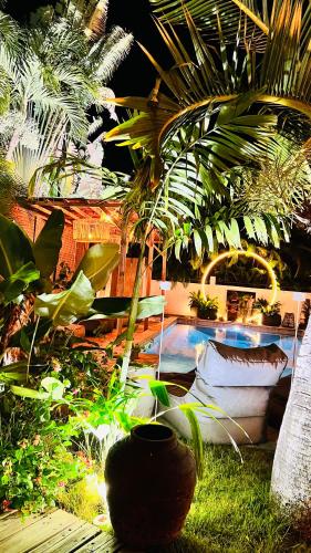 a garden with a bunch of plants and a pool at Île tropical lodges in Sainte-Anne