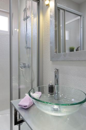 a bathroom with a glass sink and a shower at Villa Nena in Makarska
