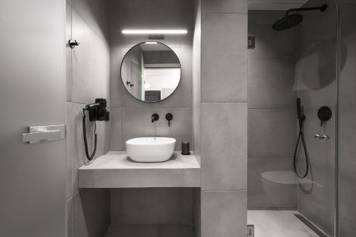 a bathroom with a sink and a mirror at ROTHOS LUXURY in Stavros