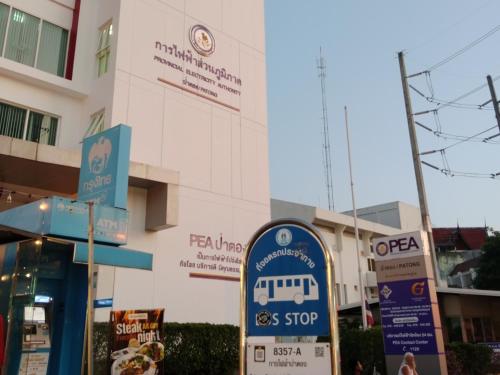 a bus stop sign in front of a building at 1919hostel in Patong Beach