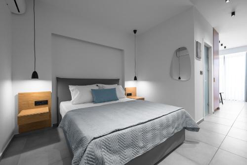 a white bedroom with a large bed in it at ROTHOS LUXURY in Stavros