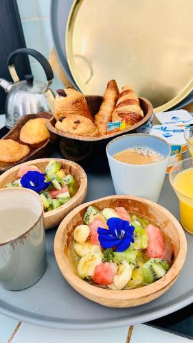 a table topped with bowls of food and bread at Île tropical lodges in Sainte-Anne