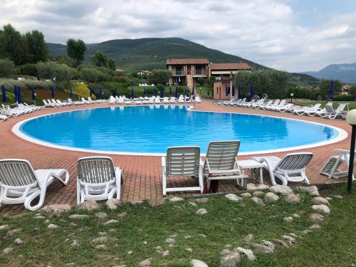 - un groupe de chaises et une piscine avec un bouquet dans l'établissement Welcome Traveller LOVELY APARTMENTS, à Castion Veronese