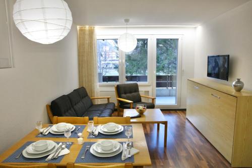 a living room with a table and a dining room at 2.5 Zimmerwohnung für Sportler & Familien WHG 132 & WHG 612 in Täsch
