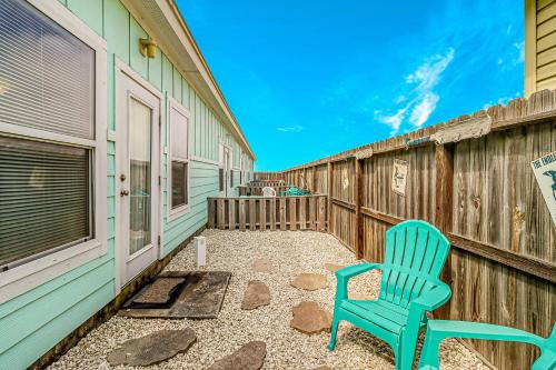 a blue chair sitting on a patio next to a fence at Nemo Cay - Endless Summer I in Padre Island