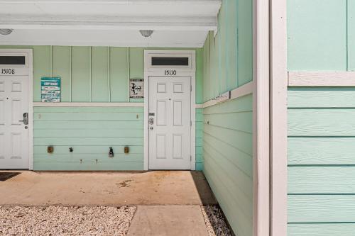 two garage doors on the side of a house at Nemo Cay - Endless Summer I in Padre Island
