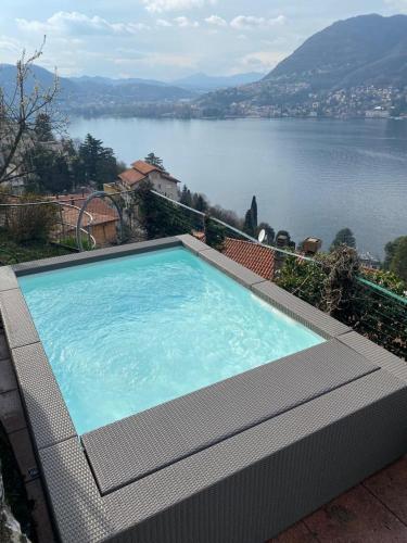 a large swimming pool with a view of a lake at VILLA Como, Jacuzzi Spa and Private Pool in Blevio
