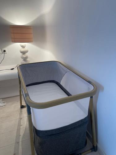 a bed in a room with a desk and a lamp at Villa ANASA private Pool & Jacuzzi 8pax at Panormos in Panormos Mykonos