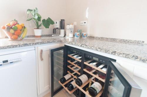 a wine rack in a kitchen with wine bottles at Villa Sound of the Sea by Portugal Collection in Aljezur