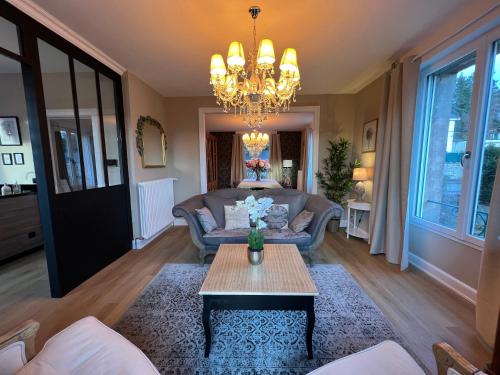 a living room with a couch and a table at Villa Agatha in Épinal