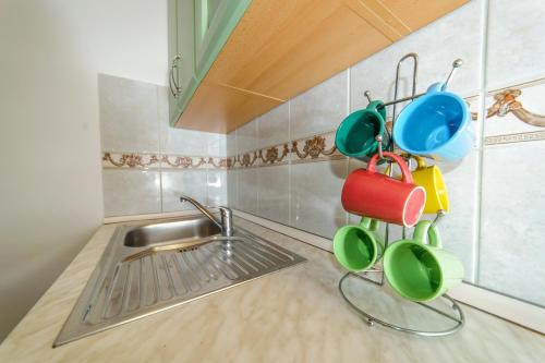 a kitchen with pots and pans hanging from the wall at Apartments & rooms Lucie in Posedarje