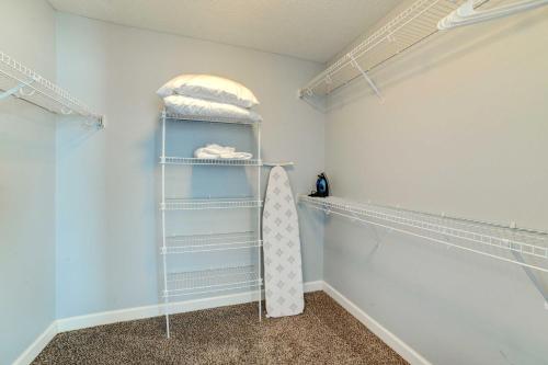 a walk in closet with a surfboard on a shelf at Family-Friendly Clarksville Vacation Rental! in Clarksville