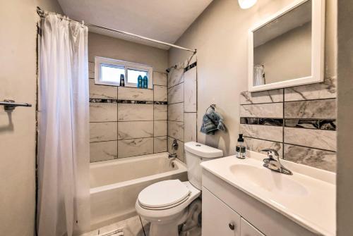 a bathroom with a toilet and a sink and a shower at St Charles Vacation Home By Historic District in St. Charles
