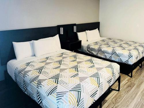 two beds sitting next to each other in a room at Motel 6-Marina, CA - Monterey in Marina