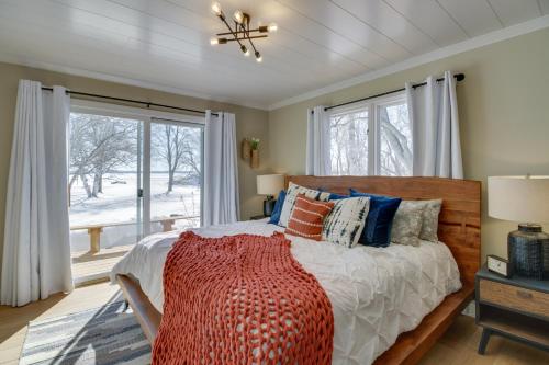 a bedroom with a bed with a large window at Home Rental on Detroit Lake Dock, Game Room! in Detroit Lakes