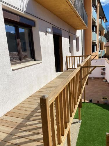 a wooden walkway leading up to a house at Apartamento acogedor in Sant Joan de les Abadesses