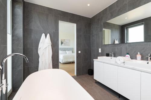 a bathroom with two sinks and a large mirror at 4bdr Modern and Stylish Apartment near Kadriorg with Free Parking in Tallinn